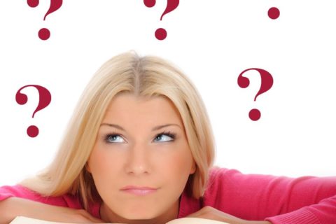 Girl and book and question marks